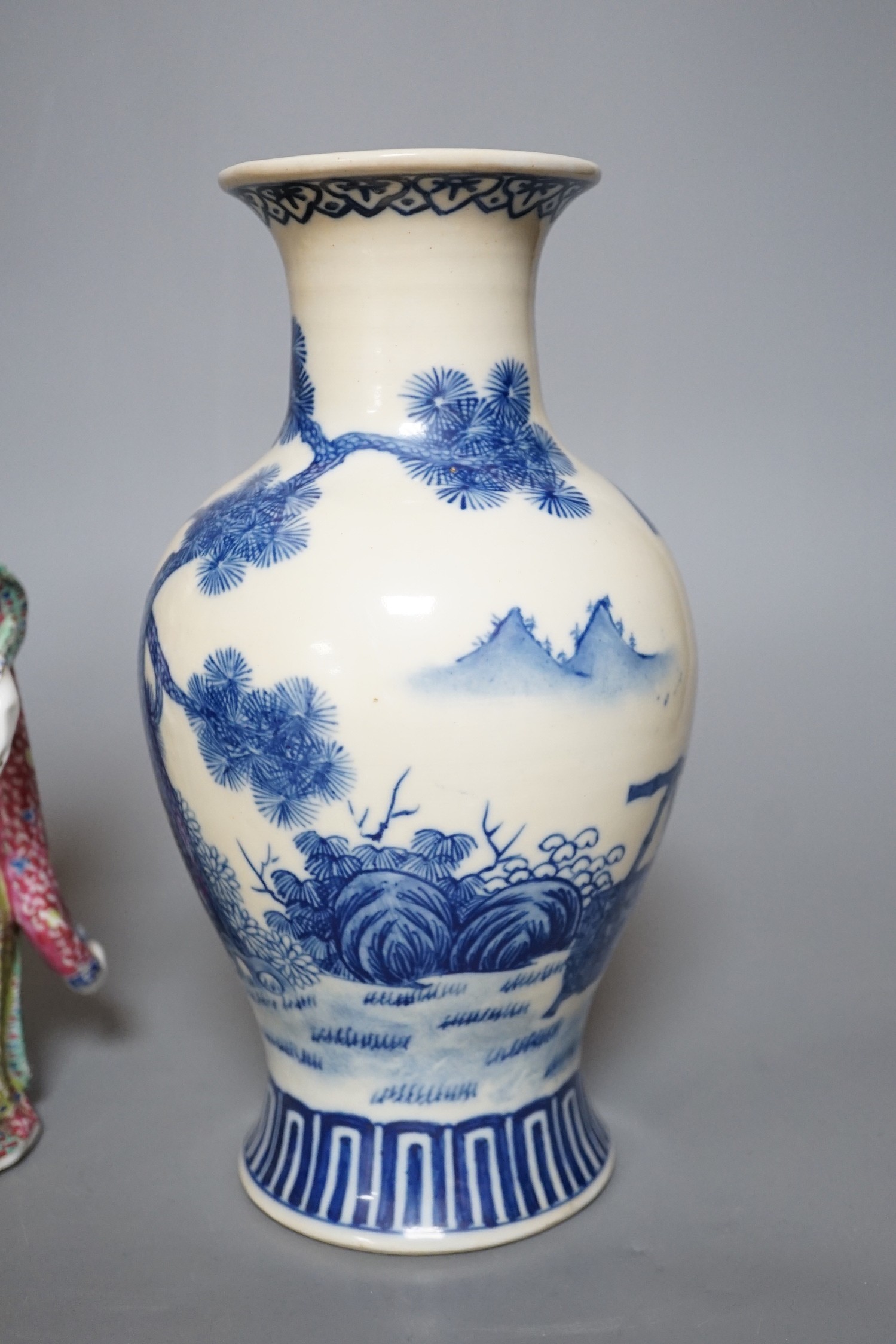 A Chinese blue and white figural vase and two polychrome figures, tallest 24cm